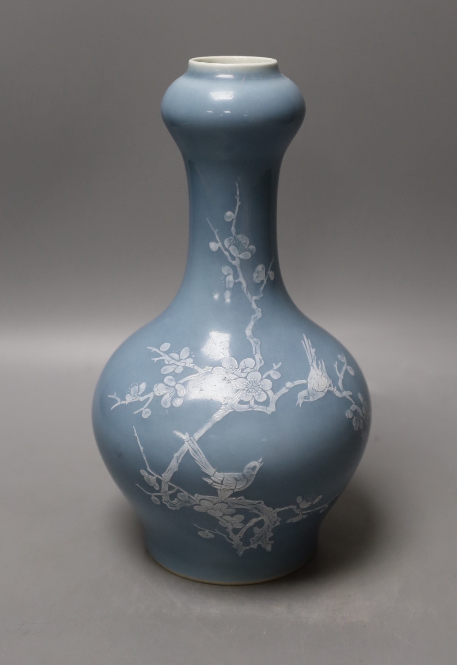 A Chinese claire de lune glazed white slip decorated vase - 25cm high